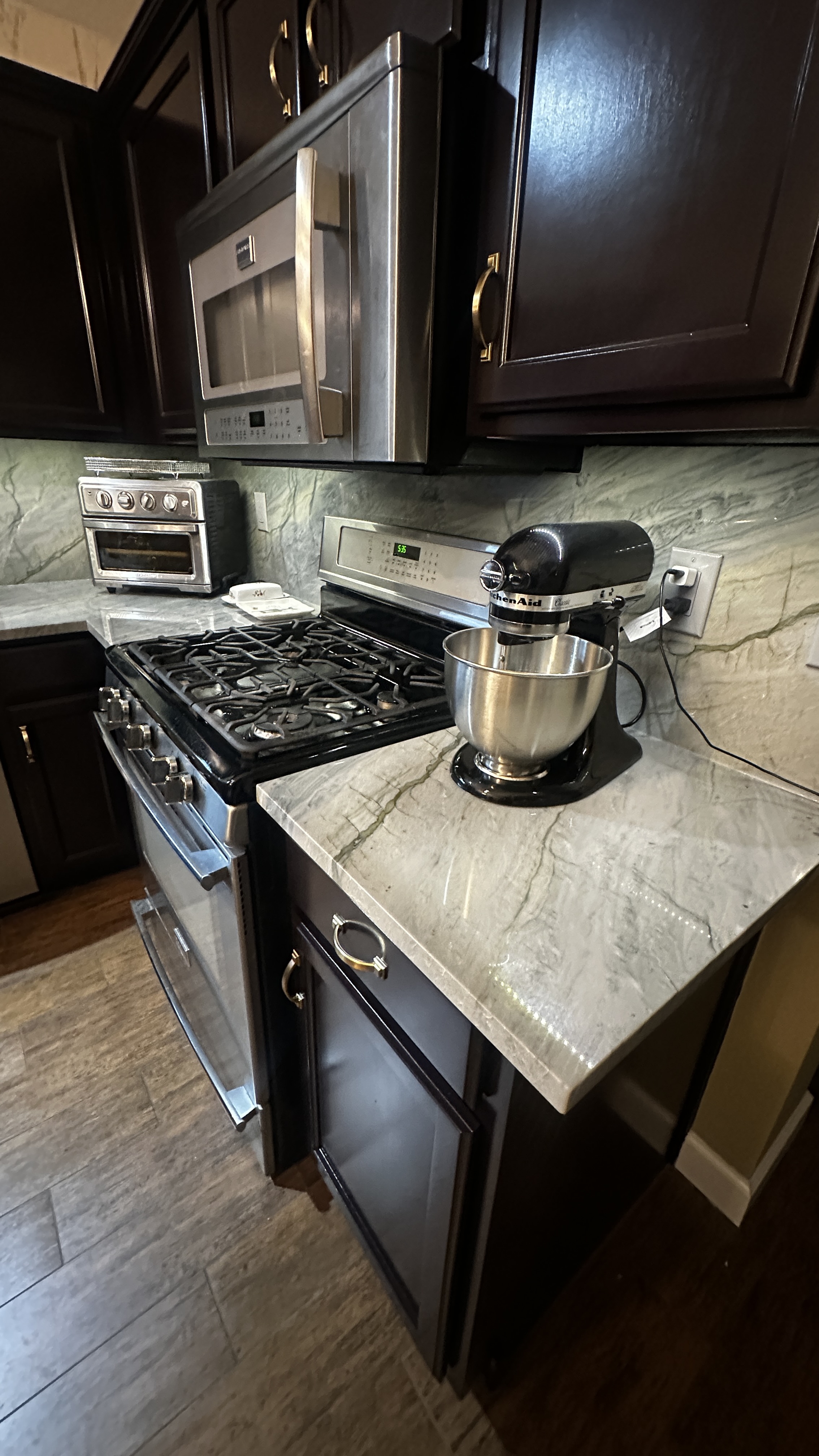 White stone countertop in a dark kitchen